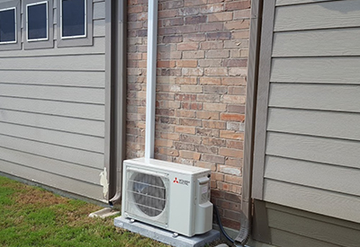 outdoor Mitsubishi ac unit installation outside of house in Dallas-Fort Worth